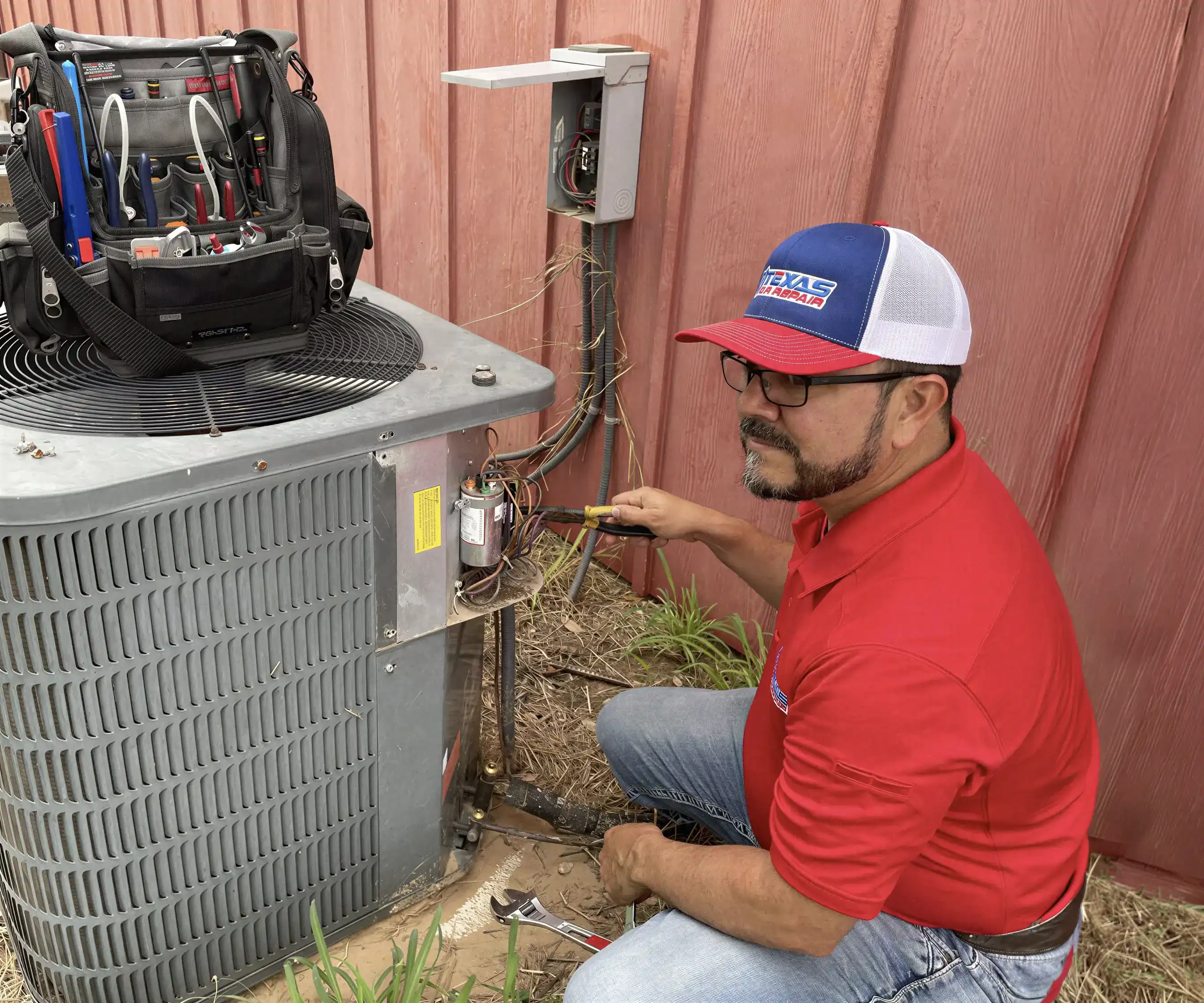 AC technician servicing a cooling unit in San Antonio